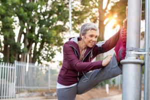 Senior woman stretching legs outdoor